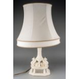 A Royal Creamware table lamp base, Neo-Classical style with Griffin supports on shaped pierced