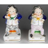 A matched pair of 19th Century squat novelty flatback figures modelled as a seated man holding a