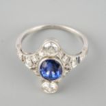 An early 20th century sapphire and diamond ring. Set with an oval shape sapphire and old cut