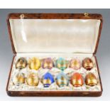 A cased harlequin set of twelve early / mid 20th century Limoges style porcelain ovoid shaped