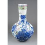 A Chinese porcelain bottle shaped vase, decorated with Famille Rose and underglaze blue