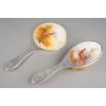 A George V silver backed dressing table hand mirror and brush with Royal Worcester porcelain