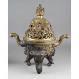 A 19th century Chineese gilt bronze and inlaid censer, the domed and pierced cover cast with a