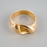 An 18ct gold snake intertwining pinky ring, eyes set for four diamond chips hallmarked to inside,