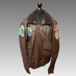 A Reproduction American WWII Patrol Squadron 49 brown leather flying jacket with four badges, faux