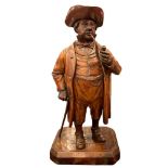 A 19th century Black Forest carved wooden novelty tobacco jar modelled as a gentleman with smoking