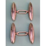 A pair of antique gold cufflinks of double lozenge design linked by an elongated bar.