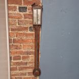A barber's pole banded mahogany stick barometer signed for G Volumbro on the side of the silvered