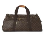Louis Vuitton, a monogram Eole 65 rolling luggage bag.