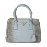 Prada, a small crocodile Galleria handbag.