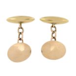 A pair of early 20th century 10ct gold oval panel and bar cufflinks