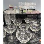 A collection of glassware: various wine glasses, some with etched decoration, mid-century waisted