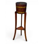 An Edwardian Oak and Brass Bound Plant Stand. R. A. Lister & Co. 91.5cm.