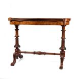 A Victorian burr walnut stretcher card table, featuring serpentine-shaped top with walnut veneer and