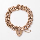 A 15ct gold chunky curb link charm bracelet, with heart shaped padlock clasp, marked 15ct to both