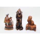 A 19th century treacle glaze model of a seated spaniel, facing left on base with rose motif, with
