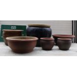 A group of garden planters in glazed finish, to include two pairs and two singles, the largest