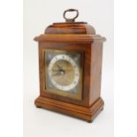 An Elliot mantle clock, made in England, retailed by Garrard & Co of London, burr walnut case, 23.