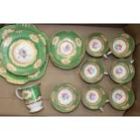 A collection of Crown Staffordshire teaware with central floral sprays, in gilt and green