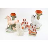 A collection of Staffordshire pottery figures to include spill vases and toby jugs etc, tallest 37cm