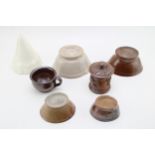 A collection of five jelly moulds, with a lidded tobacco jar, and a stoneware cup (7). Display well,