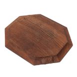 Workshop of Robert 'Mouseman' Thompson, a carved oak breadboard, of octagonal form, with canted