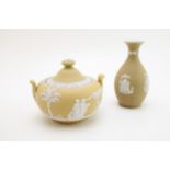 Antique Wedgwood Jasperware in yellow to include a lidded sugar jar and a bud vase (2 - both af).