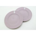 A pair of Wedgwood Lilac Jasperware Dancing Hour plates, 20.5cm diameter (2). In good condition with