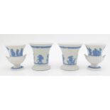 A pair of Wedgwood Blue on White Jasperware trumpet vases, 8.5cm tall, with a pair of small urns,