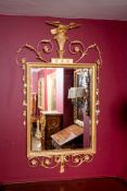 Gilt Wall Mirror with an eagle design on the top of the item