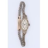 Swiss, platinum and diamond set cocktail watch, circa 1930s. The oval dial silvered with Arabic