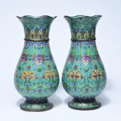 A pair of Chinese cloisonné vases, 19th century, with a slightly wavy rim and a rounded shape on a r