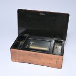 Wooden music box made of walnut with marquetry and a black lacquered interior. Central brass cylinde