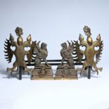 Decorative fireplace set with a grate and two andirons, made of cast iron and metal, featuring heral
