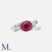 A Rubellite Tourmaline and Diamond Ring in white gold. Set with a principal cushion cut rubellite