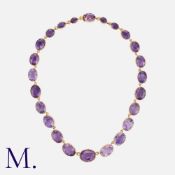 An Antique Amethyst Necklace in yellow gold with oval amethysts of graduating size in cut down