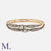 An Antique Diamond Bangle in yellow gold and silver, comprising two bands, each set with a trio of