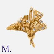 A Diamond Brooch in 18 carat yellow gold, of spray design set with round cut diamonds totalling
