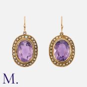A Pair of Amethyst and Pearl Cluster Earrings in yellow gold, each comprising an oval cut amethyst