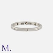 ALABASTER & WILSON, A Diamond Wedding Band in platinum, of octagonal form, with engraved decoration,