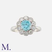 A Zircon and Diamond Cluster Ring in white gold, set with a round cut zircon of approximately 1.20