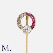 A Ruby and Diamond Stick Pin in yellow gold, the terminal designed as an open circle, set with an
