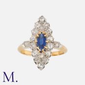 A Sapphire and Diamond Ring in 18K gold, set with a marquise cut sapphire to the centre of a