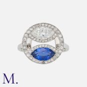 WARTSKI, A Sapphire and Diamond Ring in platinum, comprising a marquise cut sapphire of