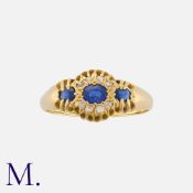 A Sapphire and Diamond Ring in 18 carat yellow gold, set with three oval cut sapphires, and rose cut