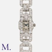 An Art Deco Diamond Cocktail Bracelet Watch in platinum, the silver dial with Arabic numerals and