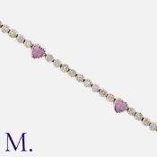 A Diamond and Pink Sapphire Bracelet in 18 carat white gold, comprising a row of round cut