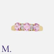 A Pink Sapphire and Diamond Ring in 18 carat yellow gold, set with three oval cut pink sapphires,