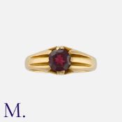 A Garnet Gypsy Ring in 18 carat yellow gold, set with a round cut garnet of approximately 1.20