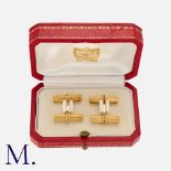CARTIER. A Pair of Cufflinks in 18K yellow gold, with ribbed batons and rope-design cufflink body.